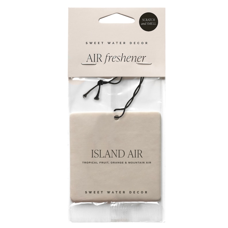 May include: An air freshener in a clear plastic package. The product is rectangular and beige, with the words "ISLAND AIR" and "TROPICAL FRUIT, ORANGE & MOUNTAIN AIR" printed on it. The packaging also includes the text "SWEET WATER DECOR" and "AIR freshener".