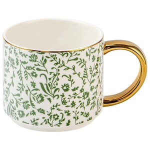 May include: White ceramic mug with a gold handle and rim. The mug is decorated with a green floral pattern. The handle is a solid gold color, and the rim has a thin gold band.