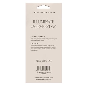 May include: A rectangular air freshener package with a die-cut hole for hanging. The package is light beige with the text "ILLUMINATE the EVERYDAY" and "AIR FRESHENER." It includes a caution notice and the text "Made in the USA."