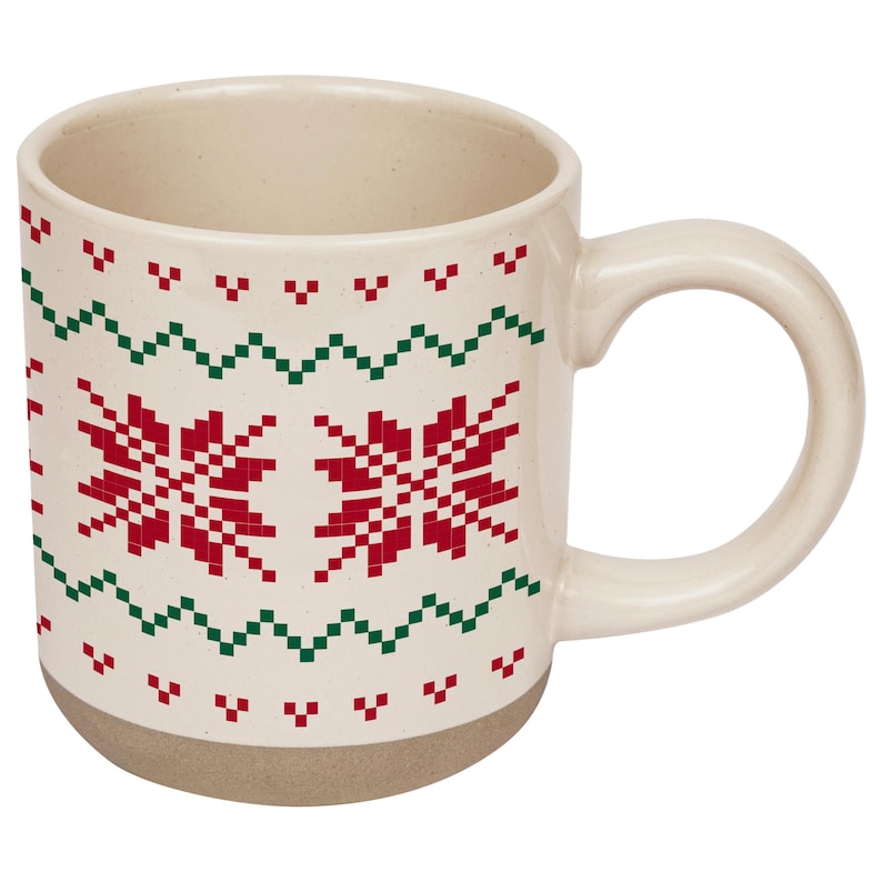 May include: A cream-colored ceramic mug featuring a repeating red and green pixelated snowflake and zigzag pattern. The mug has a smooth, glossy finish on the upper portion and a matte, unglazed base with a curved handle on the right side.