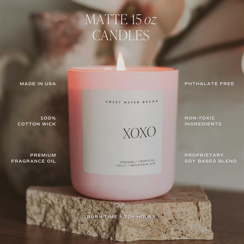 May include: A pink 15 ounce soy candle with a white label that says "Sweet Water Decor" and "XOXO". The candle has a burn time of 70+ hours and is made with non-toxic ingredients. The candle is phthalate free and has a 100% cotton wick.