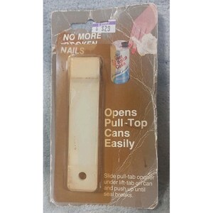May include: A vintage can opener for pull-top cans, packaged on a brown and gray cardboard backing. The opener is a light beige color and the packaging reads "NO MORE BROKEN NAILS" and "Opens Pull-Top Cans Easily."