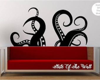 May include: Black and white wall decal of two octopus tentacles with a red couch in the foreground. The decal reads "State of the Wall".