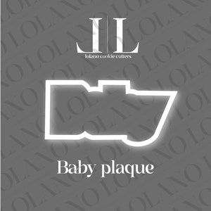 Może przedstawiać: Biała foremka do ciasteczek w kształcie tabliczki dla dziecka. Foremka znajduje się na szarym tle z napisem "Lolano cookie cutters" i "Baby plaque" nadrukowanym na biało.