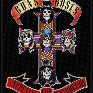May include: A black and white patch with a red and yellow banner that says "Guns N' Roses" and a red and yellow banner that says "Appetite for Destruction". The patch features a cross with five skulls on it.