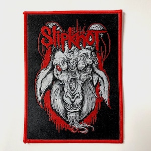 May include: Black and red embroidered patch with a white goat head and the word "Slipknot" in red lettering.