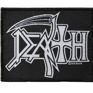 May include: A black and white embroidered patch with the word "DEATH" in a stylized font. The word is surrounded by a design that resembles a scythe. The patch has a copyright symbol and the year 2010.