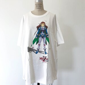 May include: White t-shirt with a graphic print of an anime character in a blue and white suit with a green cape. The text "My-hime" is printed below the character.