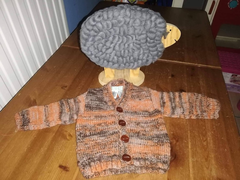 a gorgeous hand knitted cardigan to fit a child aged 0-6 months old Autumn