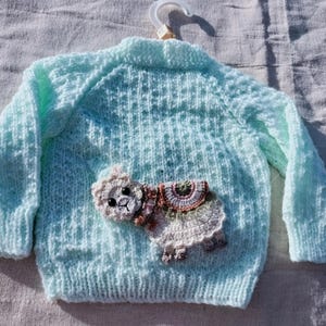 Pale Green , hand knitted baby girls Cardigan, with Llama Design.