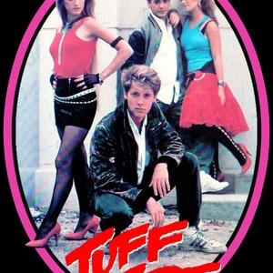May include: A pink oval frame with the words "Tuff Turf" in red letters. Inside the frame are four people, two women and two men, wearing 1980s clothing. The women are wearing short skirts and the men are wearing jackets.