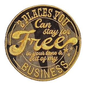 May include: Embroidered patch with the text "2 PLACES YOU Can stay for Free in your lane & out of my BUSINESS". The patch is circular, with gold and black colors.
