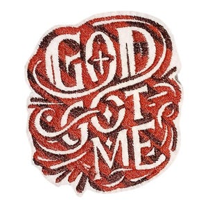 May include: A white, red, and brown patch with the words "GOD GOT ME" in a stylized, cursive font. The patch has a textured, embroidered appearance, with a cross symbol incorporated into the design.