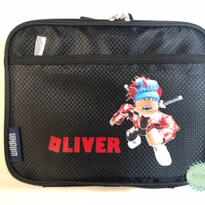 May include: Black rectangular Wildkin lunch bag with a zipper closure. The bag features a Roblox-style character graphic and the name "OLIVER" in red block letters. A small silver pen is in the front pocket.