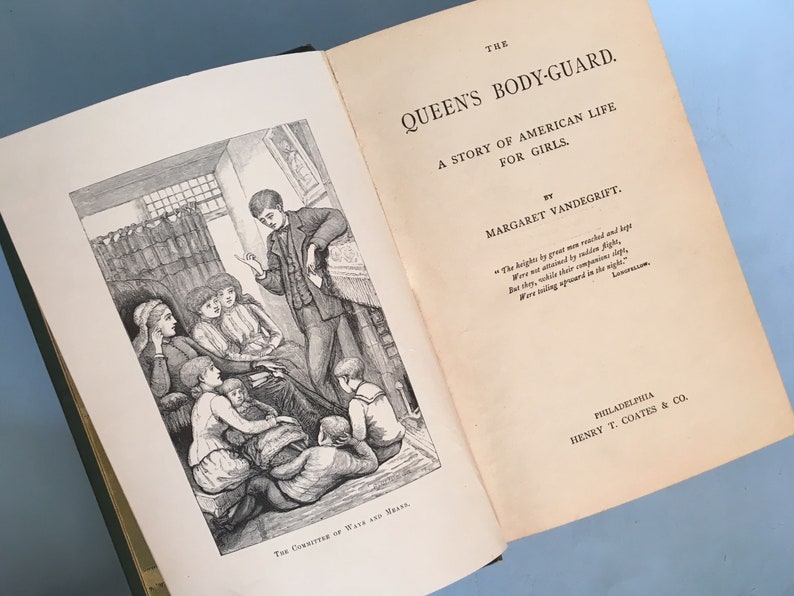 May include: Open book with the title "The Queen's Body-Guard" and illustrations. The book's pages are aged with text and a black and white illustration of a group of people. The book is a story of American life for girls.
