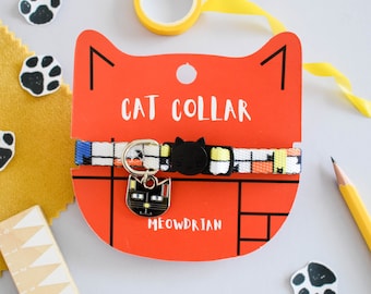 May include: A red cat collar with a black and white patterned strap and a black cat charm. The collar is labelled "Cat Collar" and "Meowdrian".