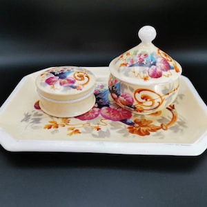 Delightful ceramic three piece victorian vanity dressing table set. Tray, powder pot and lidded trinket dish. An abundance of flowers.