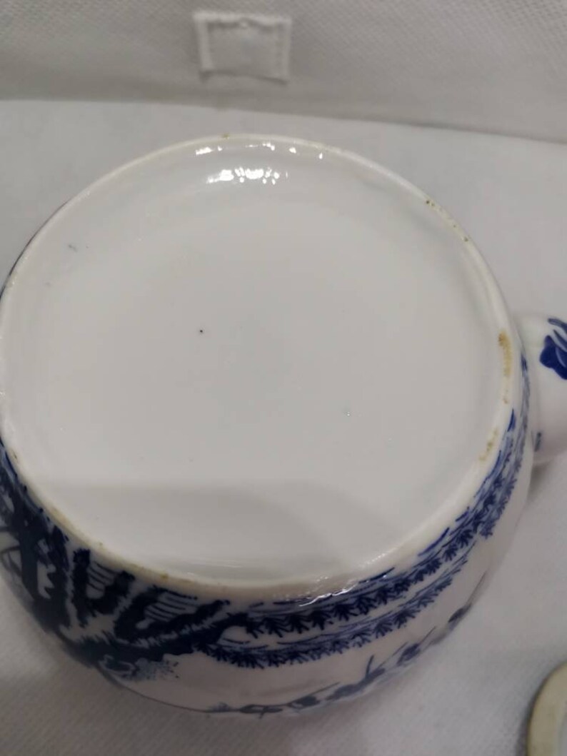 No markings. Blue and white Chinese design teapot Wicker bamboo handle