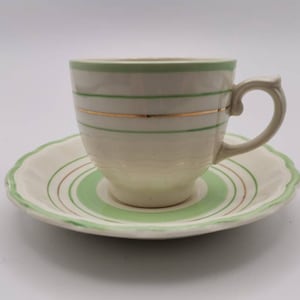 Superb Woods Ivory ware Art Deco demitasse cup and saucer set. Green and gold stripe.