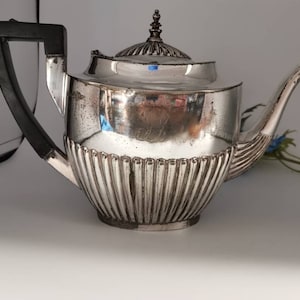 Lovely silver plated Walker and Hall vintage tea pot. Distressed, with ebonised handle.