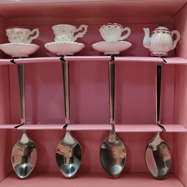 Pretty set of four teaspoons with cups and saucer handles.