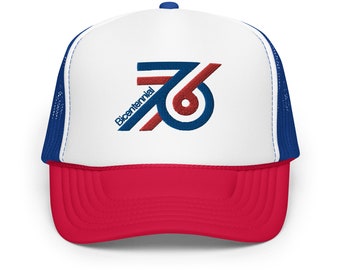 May include: A white and red trucker hat with a blue mesh back. The front of the hat features a blue and red logo with the text "Bicentennial 76".