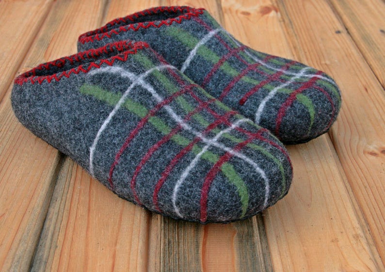May include: A pair of gray wool slippers with a red, green, and white plaid pattern.