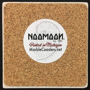 May include: A cork coaster with a white circle sticker that says "Naamaah" with a registered trademark symbol, "Est. 1992", "Printed in Michigan", and "MarbleCoasters.net".