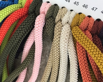 May include: A close-up of a colour chart with various shades of cord. The cords are arranged in a row, with the numbers 41 through 47 visible on the chart.