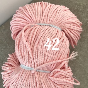 May include: A large spool of pink cotton cord, with the number 42 printed on the side.