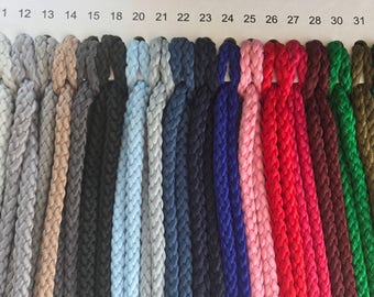 May include: A color chart of 20 different colors of cotton cord. The cord is braided and has a textured look. The colors range from yellow to green.