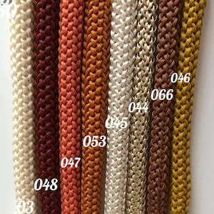 May include: Close-up of eight different colors of braided cord, with numbers 03, 046, 066, 044, 045, 053, 047, and 048 visible.
