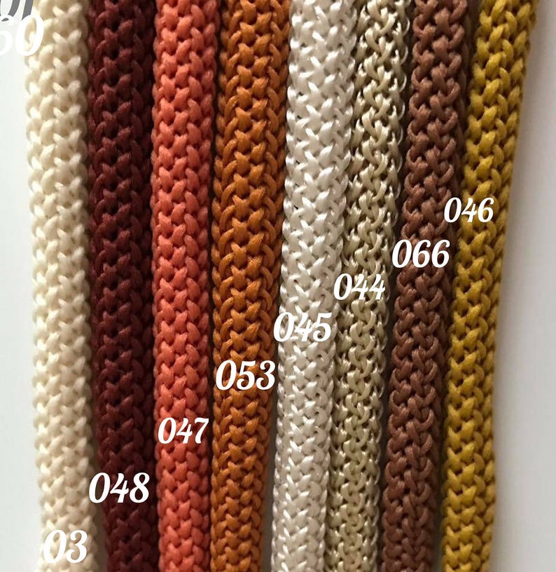May include: Close-up of eight different colors of braided cord, with numbers 03, 046, 066, 044, 045, 053, 047, and 048 visible.