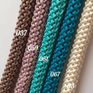 May include: Five different colors of braided rope, from left to right: brown, pink, turquoise, blue, and white. The rope is labeled with numbers: 037, 059, 051, 067, and 03.