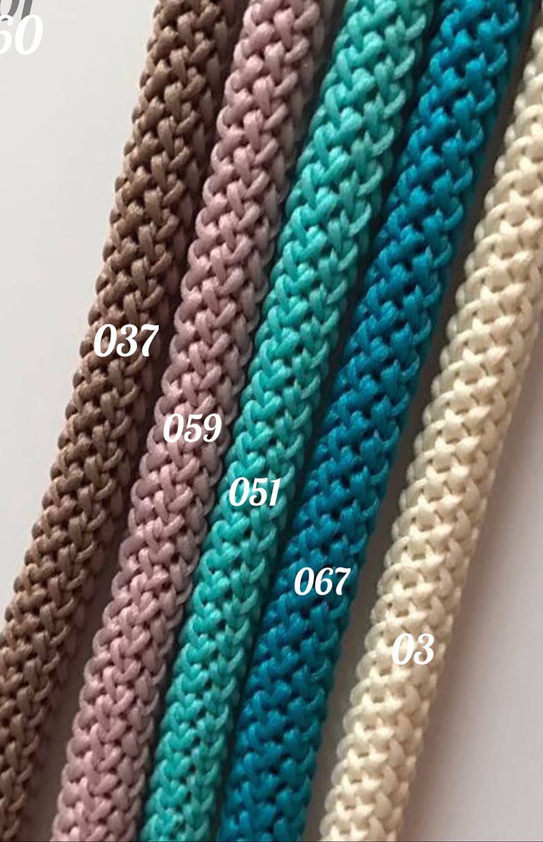May include: Five different colors of braided rope, from left to right: brown, pink, turquoise, blue, and white. The rope is labeled with numbers: 037, 059, 051, 067, and 03.