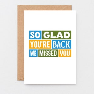 May include: A white greeting card with the message "SO GLAD YOU'RE BACK WE MISSED YOU" in blue, green, and yellow block letters. The card is inside a brown envelope.