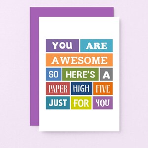 May include: A white card with the text "You are awesome so here's a paper high five just for you" in colourful blocks.