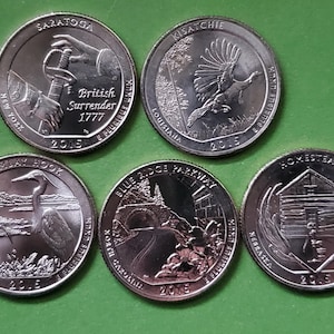 May include: Five United States quarter coins. The coins feature designs for Saratoga, Kisatchie, Bombay Hook, Blue Ridge Parkway, and Homestead. Each coin is dated 2015 and has text such as "British Surrender 1777".