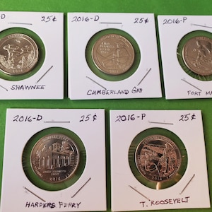 May include: Five 2016 quarter coins in white cardboard holders. The coins feature designs for Shawnee, Cumberland Gap, Fort Moultrie, Harpers Ferry, and T. Roosevelt. Each holder is labeled with "2016-D" or "2016-P" and "25¢".
