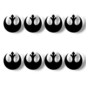 May include: Eight black Rebel Alliance starbird symbols, also known as the Rebel Alliance logo, are arranged in two rows of four. The symbols are on a white background.