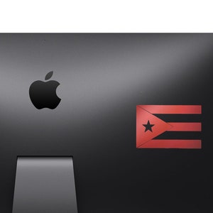May include: A black computer monitor with a silver Apple logo and a red, white and blue Cuban flag sticker on the right side.
