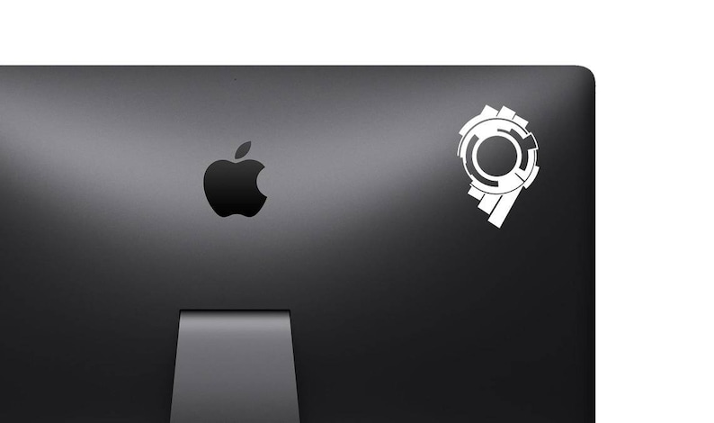 May include: A black laptop computer with a white apple logo and a white sticker of a stylized number nine with a circle in the center.