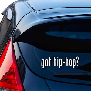May include: A black car with a white vinyl sticker on the back window that says "got hip-hop?"