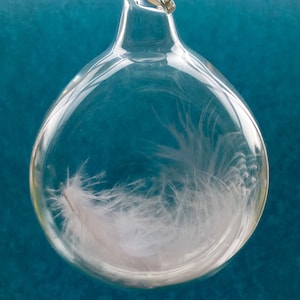 After a death, a tender gift for a grieving heart, a blown glass tear drop with one white angel feather inside with tender words of comfort. image 1