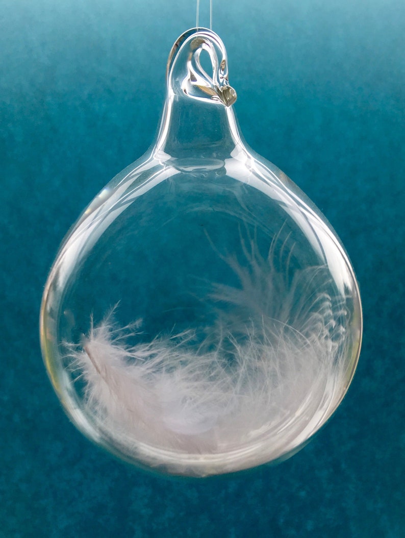 After a death, a tender gift for a grieving heart, a blown glass tear drop with one white angel feather inside with tender words of comfort. image 1