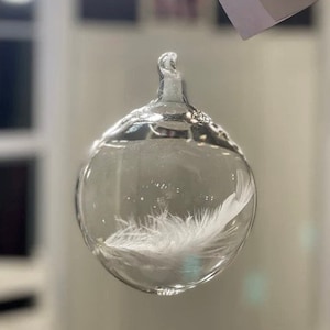 After miscarriage, the tender gift of an angel feather in blown glass with words of comfort, helps soothe a broken heart.