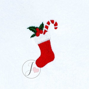May include: Red and white Christmas stocking with a candy cane and holly sprig embroidery.