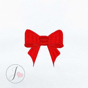 May include: A red satin bow with a center knot. The bow is isolated on a white background.