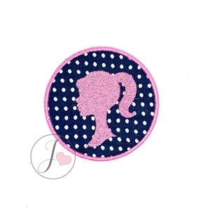 May include: A pink silhouette of a woman with a ponytail on a navy blue background with white polka dots. The circle is outlined in pink.