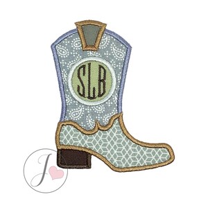 Puede incluir: Una bota vaquera azul y marrón con un estampado de paisley y un círculo con monograma que dice "SLB" en letras marrones.